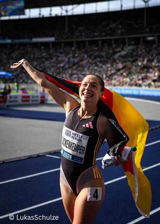 Eine Athletin zeigt die deutsche Flagge mit Begeisterung.