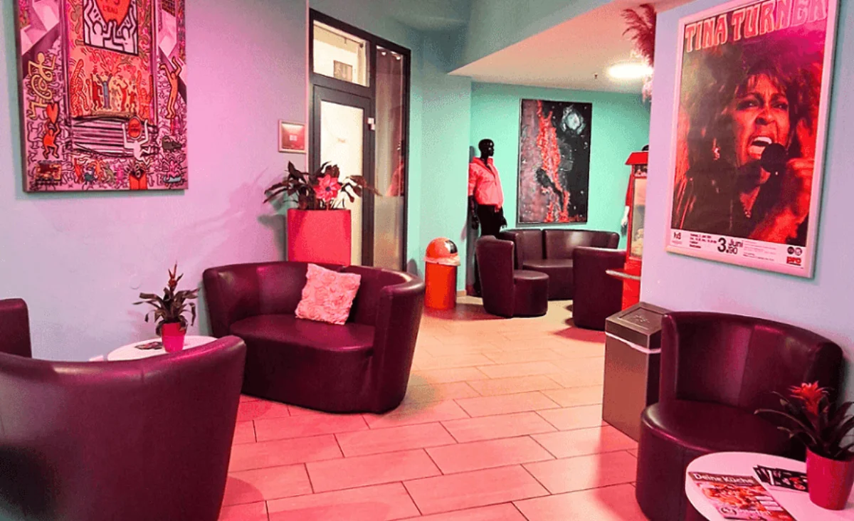 Ein Raum mit schwarze Stühlen und rosa Wänden, der eine harmonische und farbenfrohe Umgebung bietet.